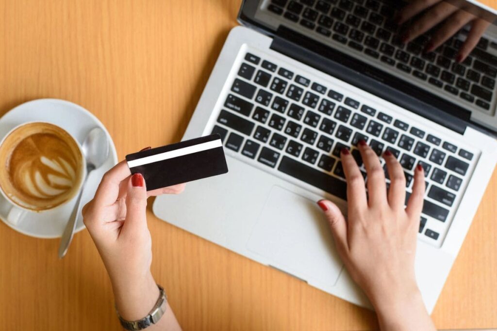 Person using laptop with gift card